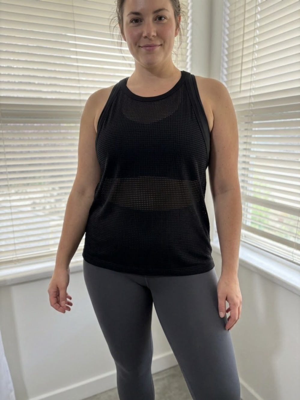 Reitmans sheer black sleeveless tank.